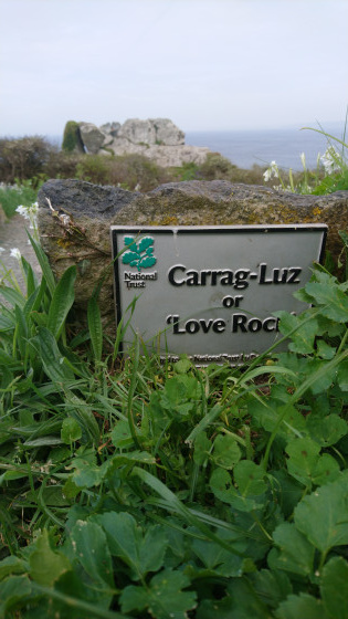 Carrag-Luz, National Trust sign for the nearby cliff edge, and rocks