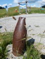 Exploded shell used as a bollard.