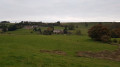 Path in farmland overlooking "The Kingscote Barn" far away